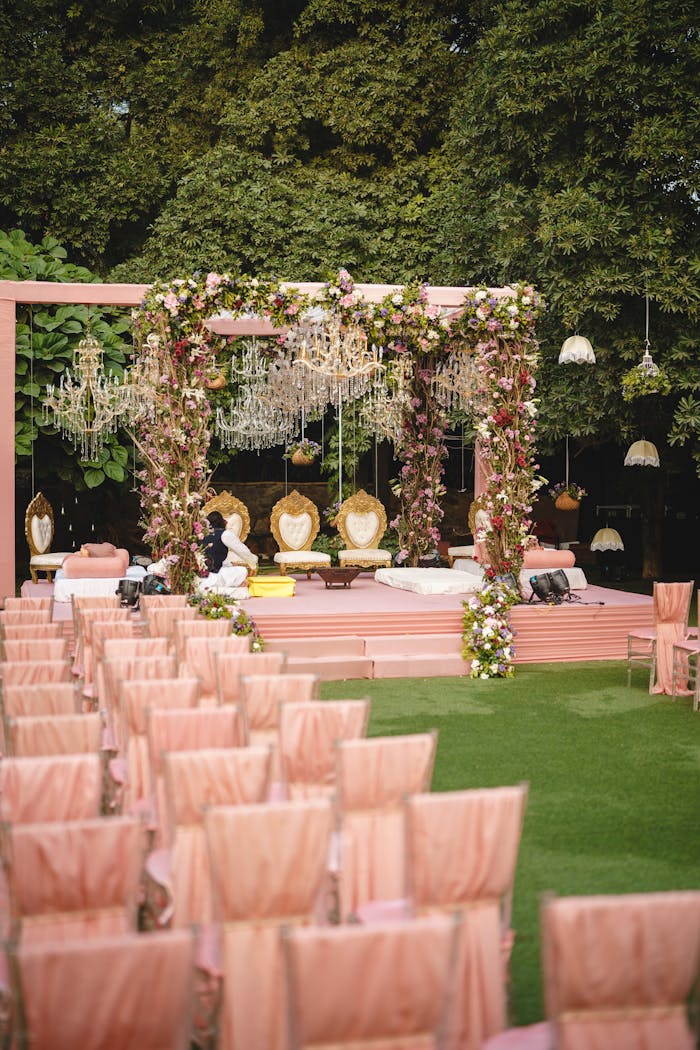 about-01 Romantic outdoor wedding ceremony with floral arches and elegant seating on a sunny day.